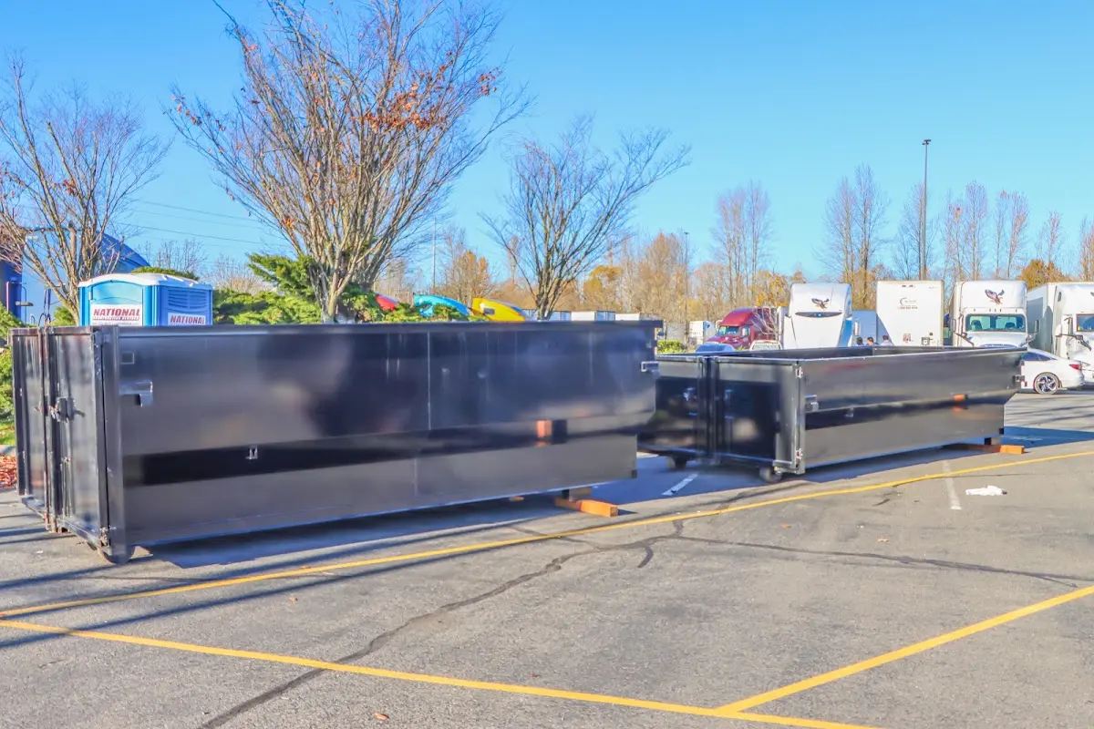 Professional dumpster rental service with roll-off container on residential driveway in Oshtemo